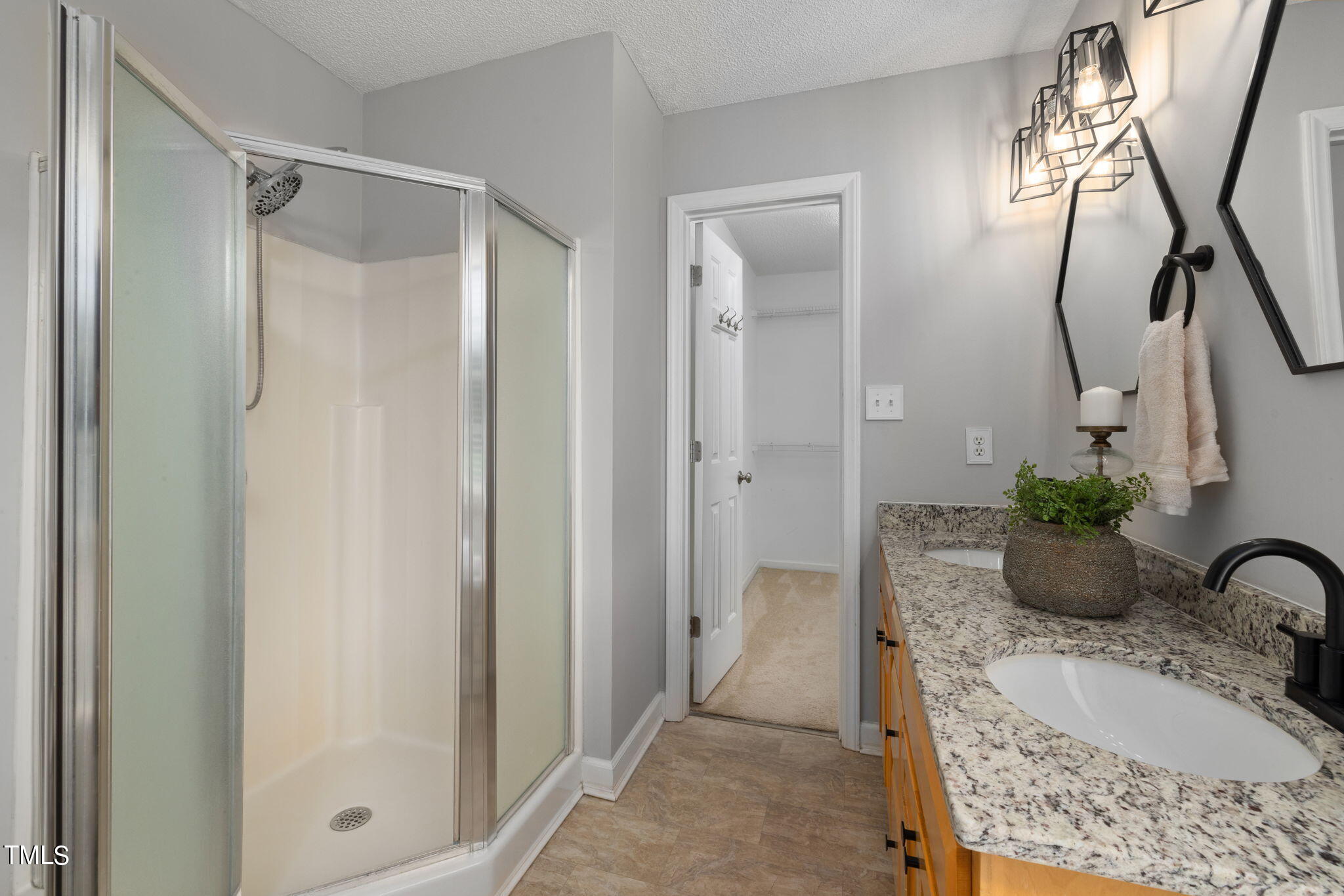 1500 Harvey Johnson Road Raleigh, NC 27603 - Photo 31 of 42 a bathroom with a granite countertop sink a mirror and shower
