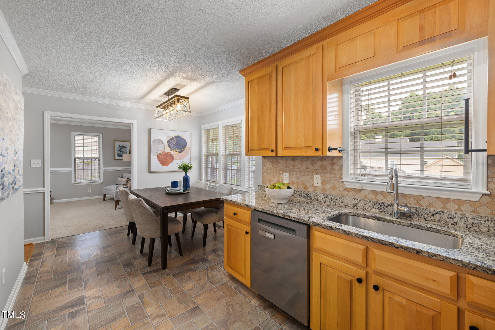 1500 Harvey Johnson Road Raleigh, NC 27603 - Photo 8 of 42 a kitchen with kitchen island granite countertop a sink cabinets and window