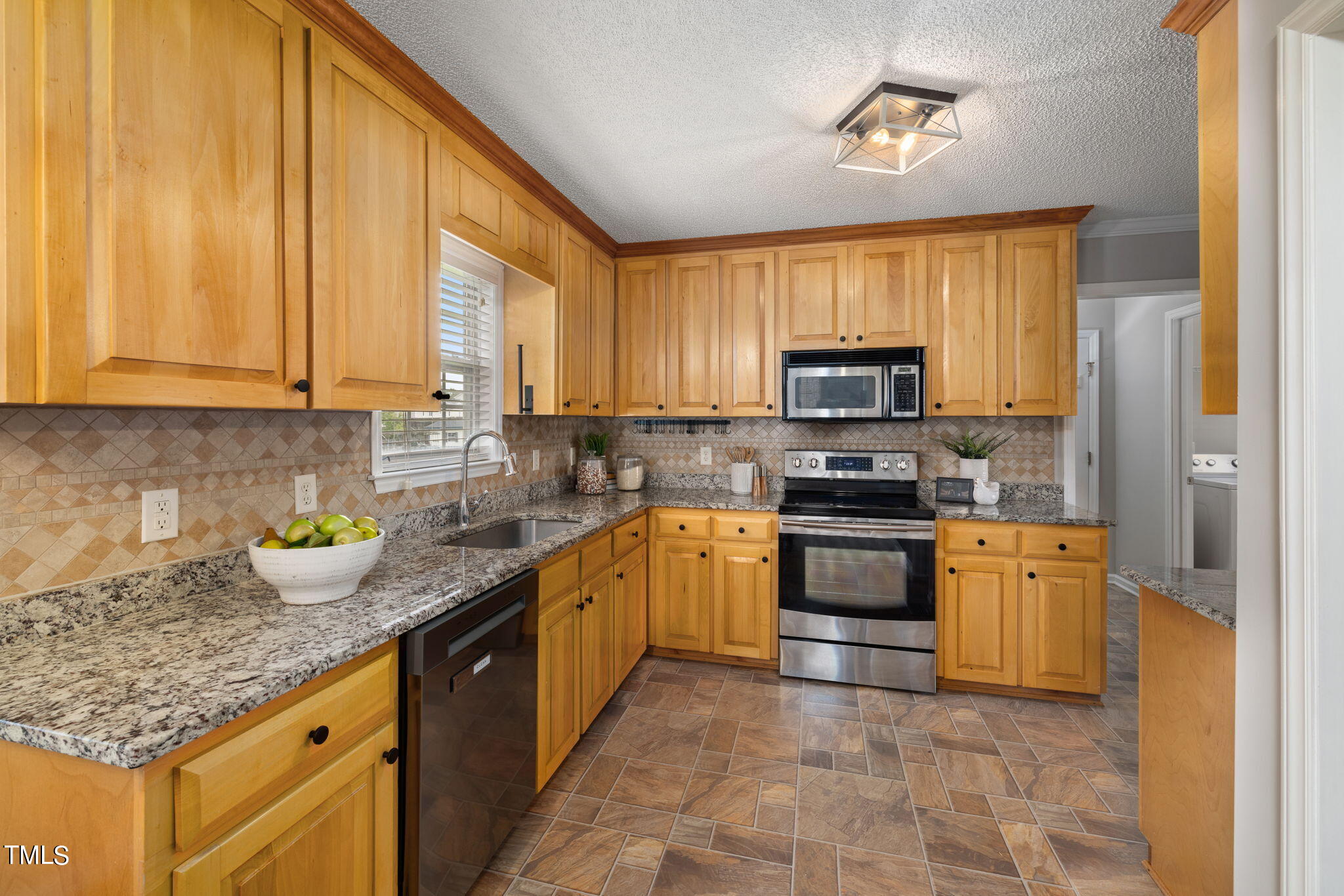 1500 Harvey Johnson Road Raleigh, NC 27603 - Photo 9 of 42 a kitchen with granite countertop a stove sink and cabinets