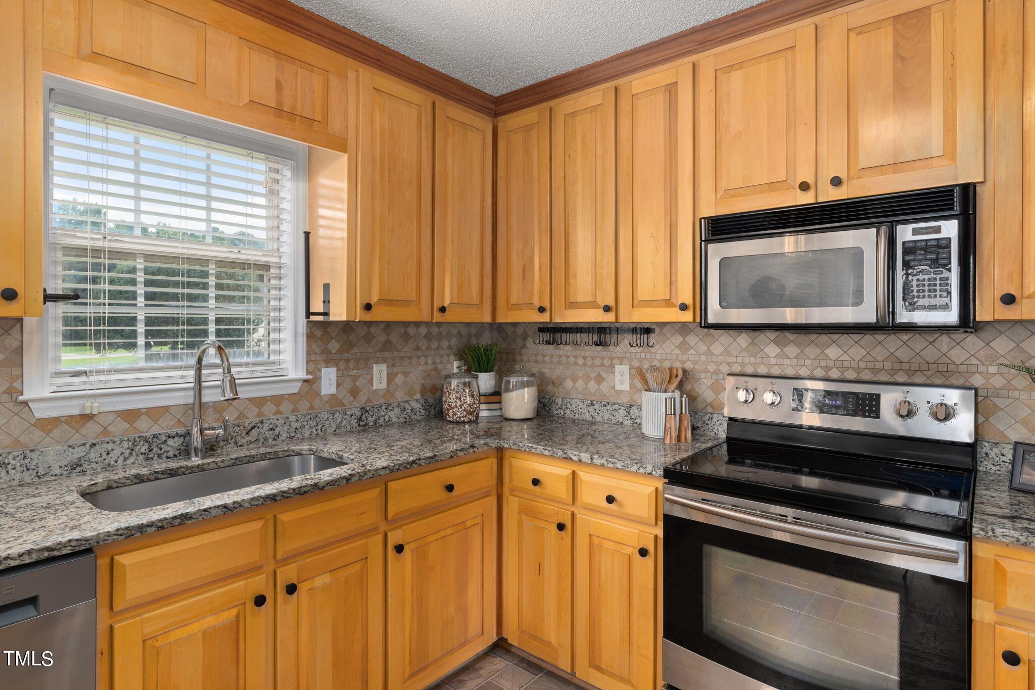 1500 Harvey Johnson Road Raleigh, NC 27603 - Photo 10 of 42 a kitchen with granite countertop cabinets stainless steel appliances and a sink