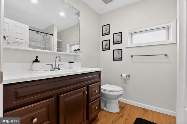 a bathroom with a sink a toilet and mirror