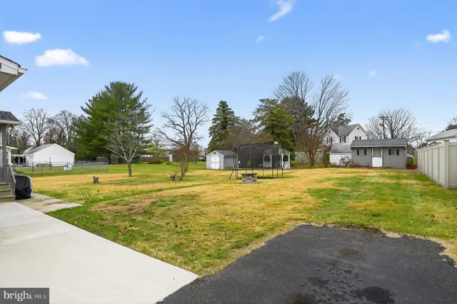 a swimming pool with outdoor seating and yard