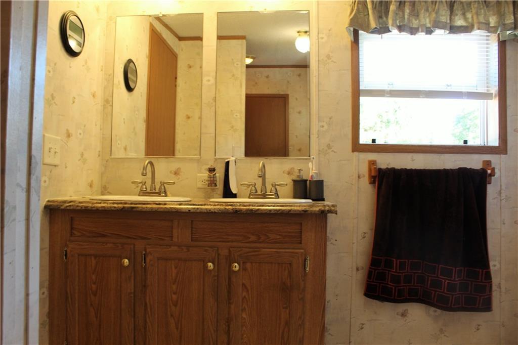 349 Country Lane Road Prospect, PA 16052 - Photo 15 of 25 a bathroom with a granite countertop sink a mirror and a shower