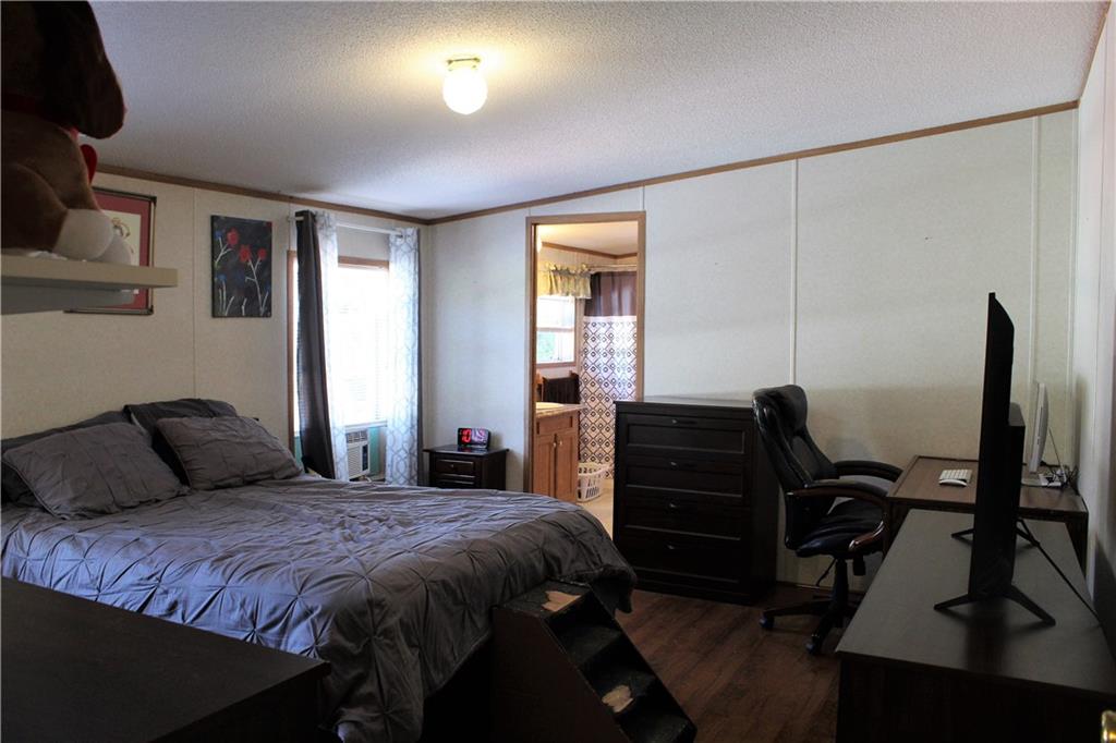 349 Country Lane Road Prospect, PA 16052 - Photo 17 of 25 a bedroom with a bed and wooden floor