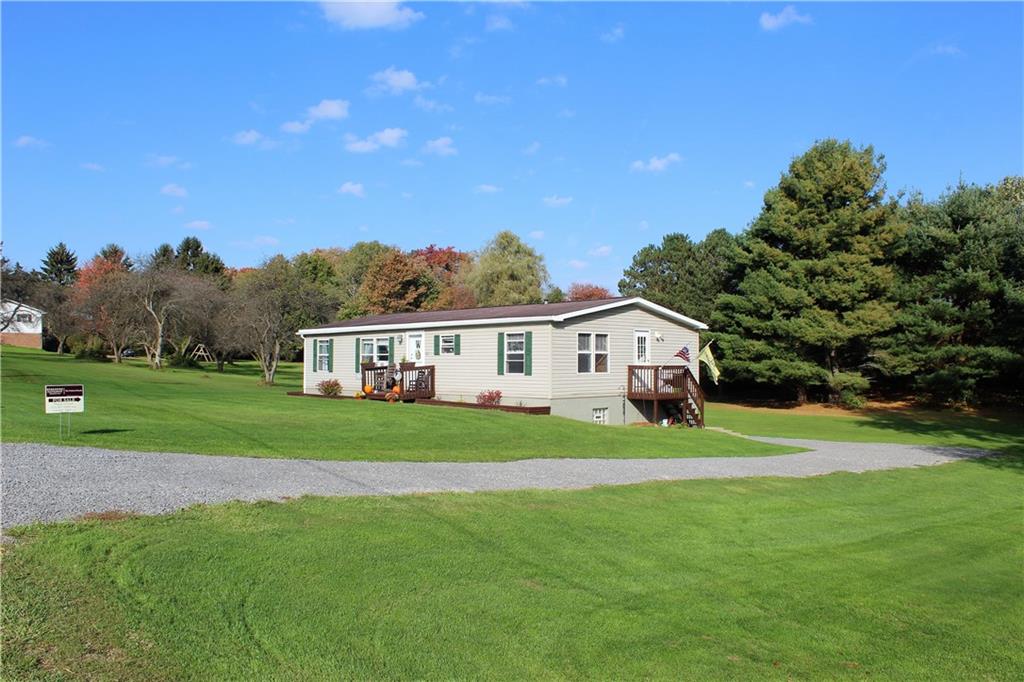 349 Country Lane Road Prospect, PA 16052 - Photo 20 of 25 a house that is sitting in the grass with large trees and plants