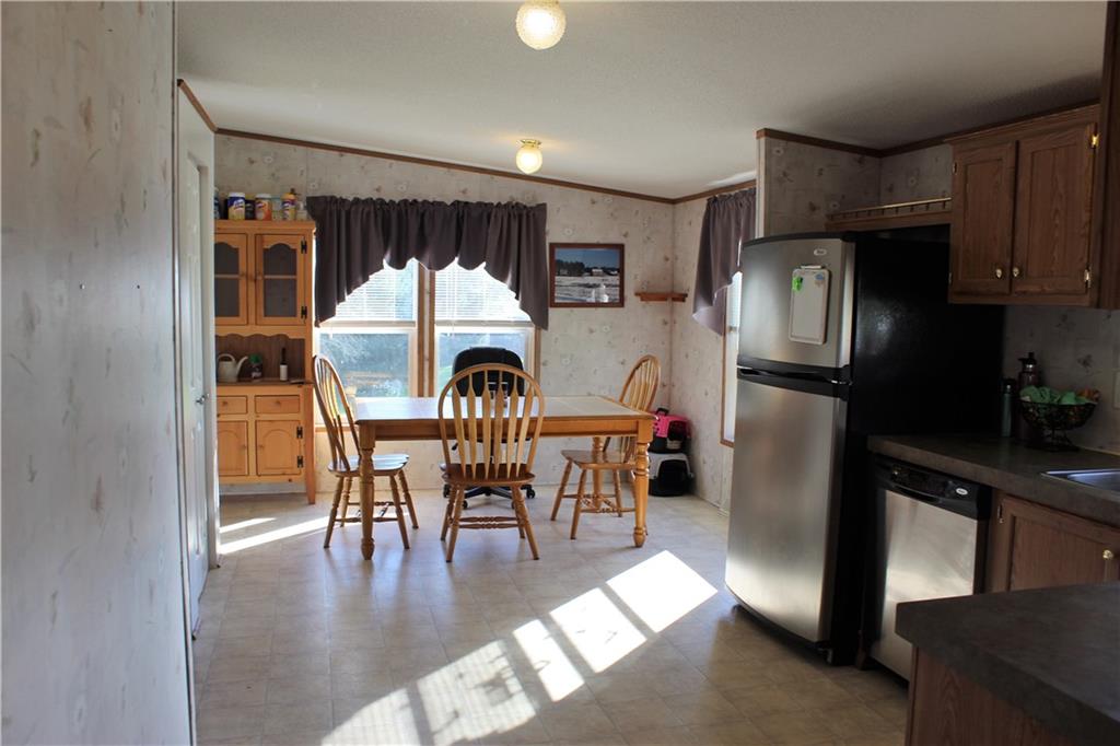 349 Country Lane Road Prospect, PA 16052 - Photo 6 of 25 a kitchen with a table chairs refrigerator and microwave