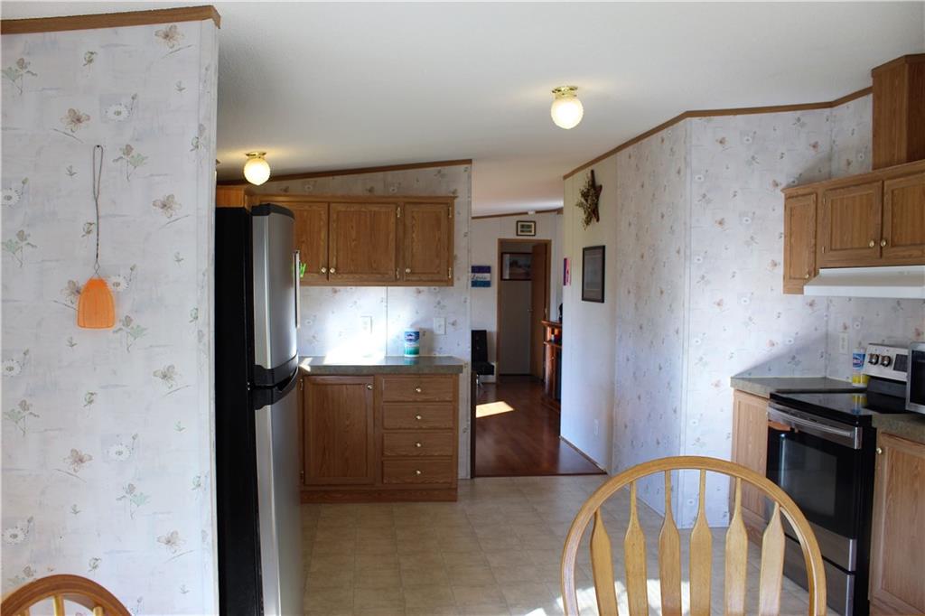 349 Country Lane Road Prospect, PA 16052 - Photo 7 of 25 a kitchen with stainless steel appliances granite countertop a refrigerator a stove and a sink with wooden floor