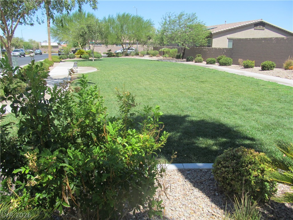 2157 Rio Rancho Pointe Place Henderson, NV 89002 - Photo 23 of 24 A neatly manicured lawn with mature landscaping defines this property's welcoming front yard.