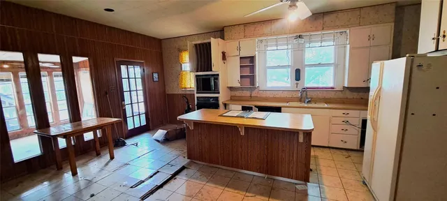 a kitchen with a sink stove and cabinets