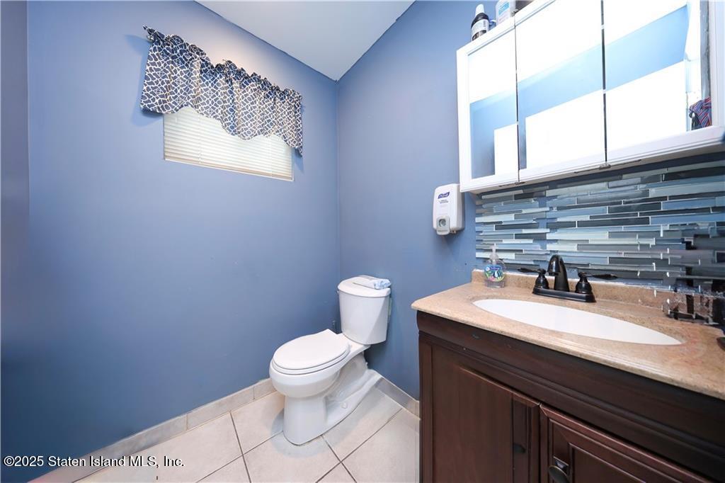 20 Buel Avenue, Unit A Staten Island, NY 10304 - Photo 11 of 30 a bathroom with a sink a toilet and mirror