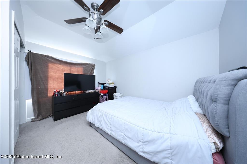 20 Buel Avenue, Unit A Staten Island, NY 10304 - Photo 12 of 30 a bedroom with a bed and a flat screen tv