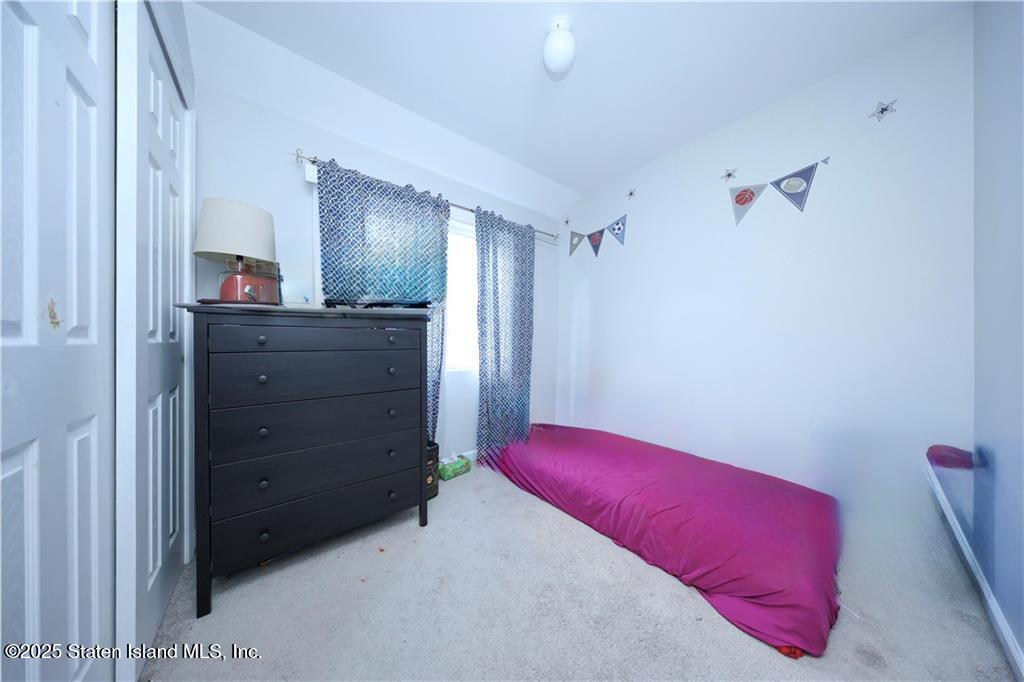 20 Buel Avenue, Unit A Staten Island, NY 10304 - Photo 16 of 30 a bedroom with a bed and a dresser
