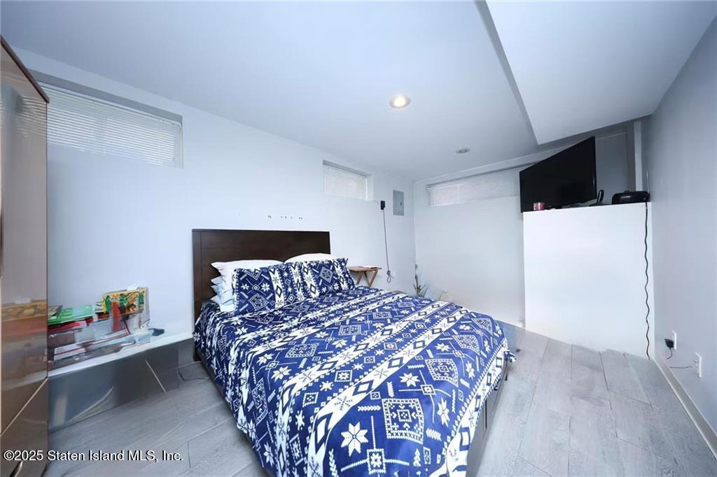 20 Buel Avenue, Unit A Staten Island, NY 10304 - Photo 18 of 30 a bedroom with a bed and a potted plant