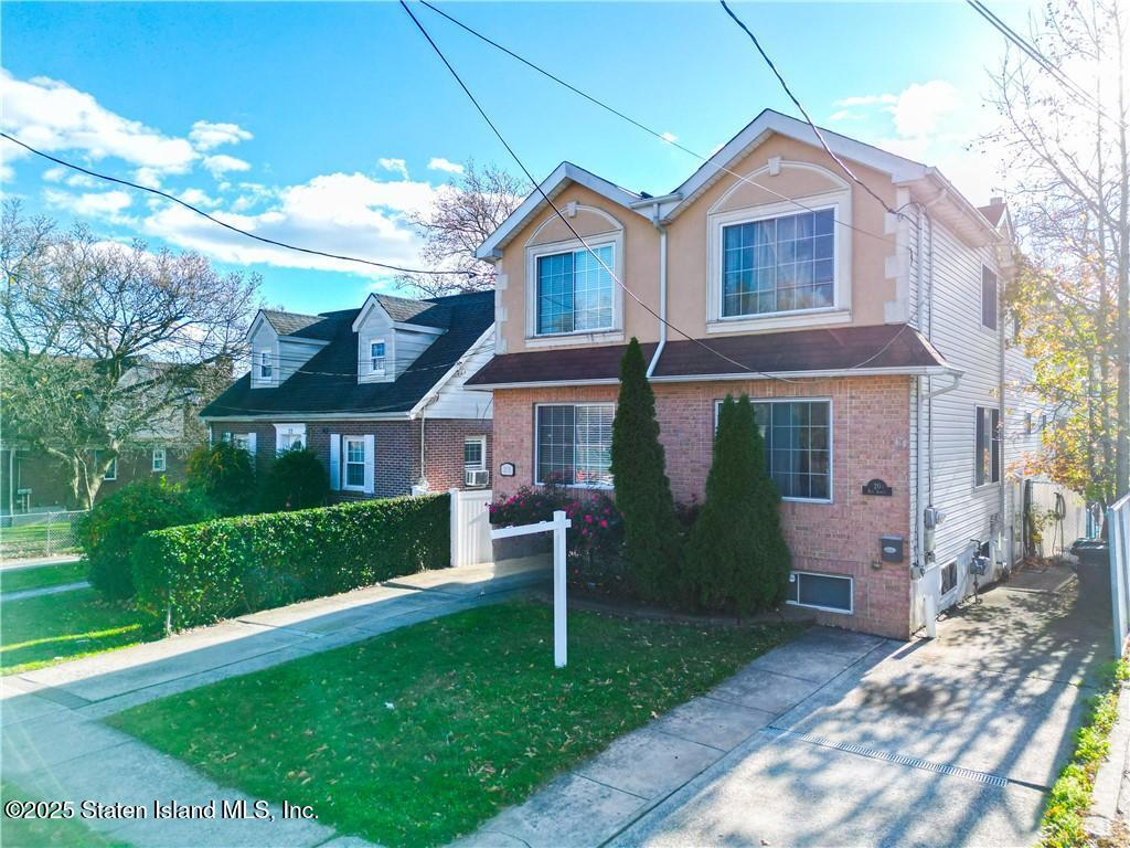 20 Buel Avenue, Unit A Staten Island, NY 10304 - Photo 29 of 30 a front view of a house with a yard
