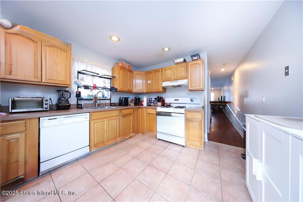20 Buel Avenue, Unit A Staten Island, NY 10304 - Photo 9 of 30 a kitchen with stainless steel appliances granite countertop a stove sink and cabinets