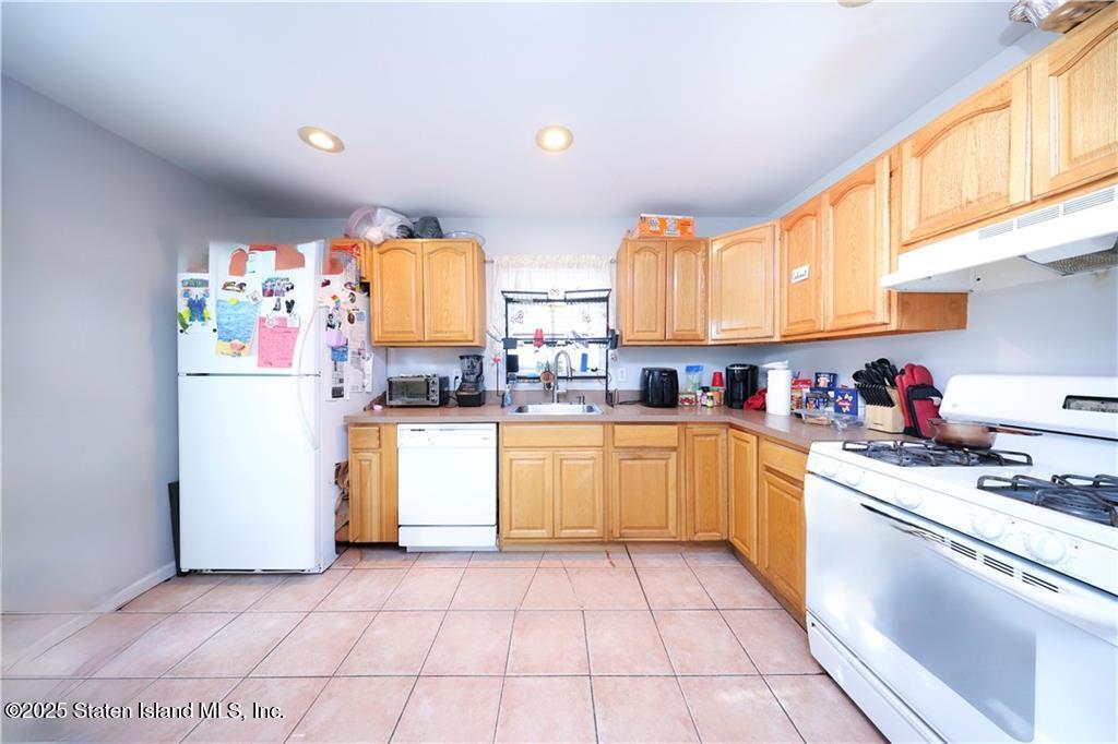 20 Buel Avenue, Unit A Staten Island, NY 10304 - Photo 10 of 30 a kitchen with a white cabinets and white appliances