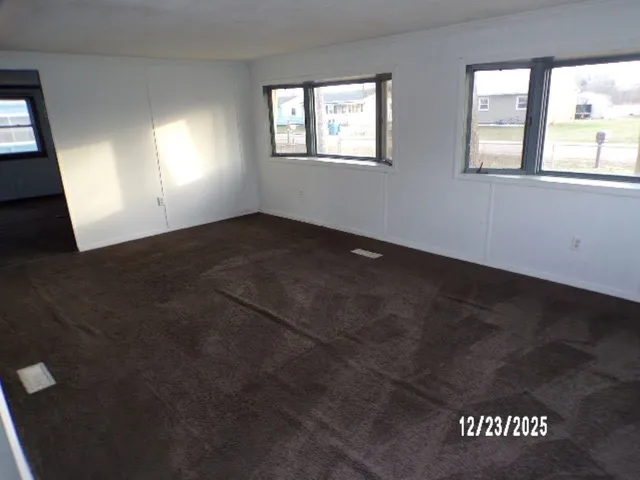 a view of a small house with a yard