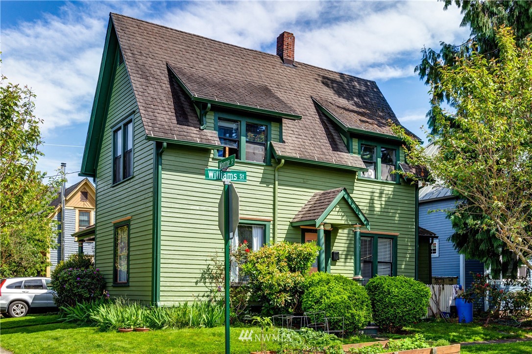 1717 Monroe Street Bellingham, WA 98225 - Photo 1 of 37 a front view of a house with a garden