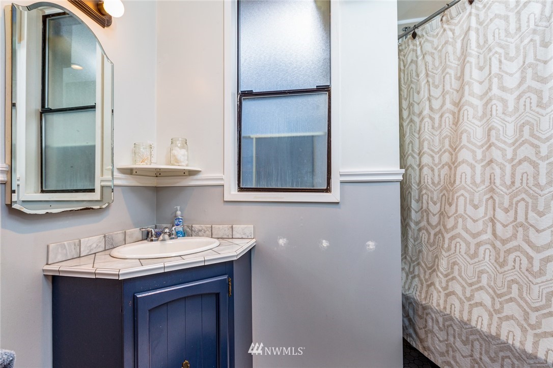 1717 Monroe Street Bellingham, WA 98225 - Photo 12 of 37 a bathroom with a sink and a mirror