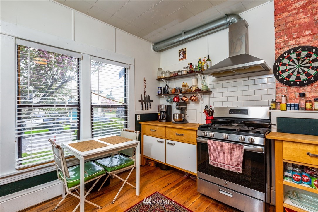 1717 Monroe Street Bellingham, WA 98225 - Photo 15 of 37 a kitchen with stainless steel appliances granite countertop a stove and a sink
