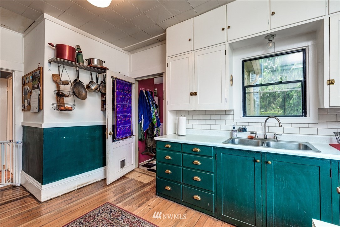 1717 Monroe Street Bellingham, WA 98225 - Photo 16 of 37 a kitchen with a sink cabinets and window