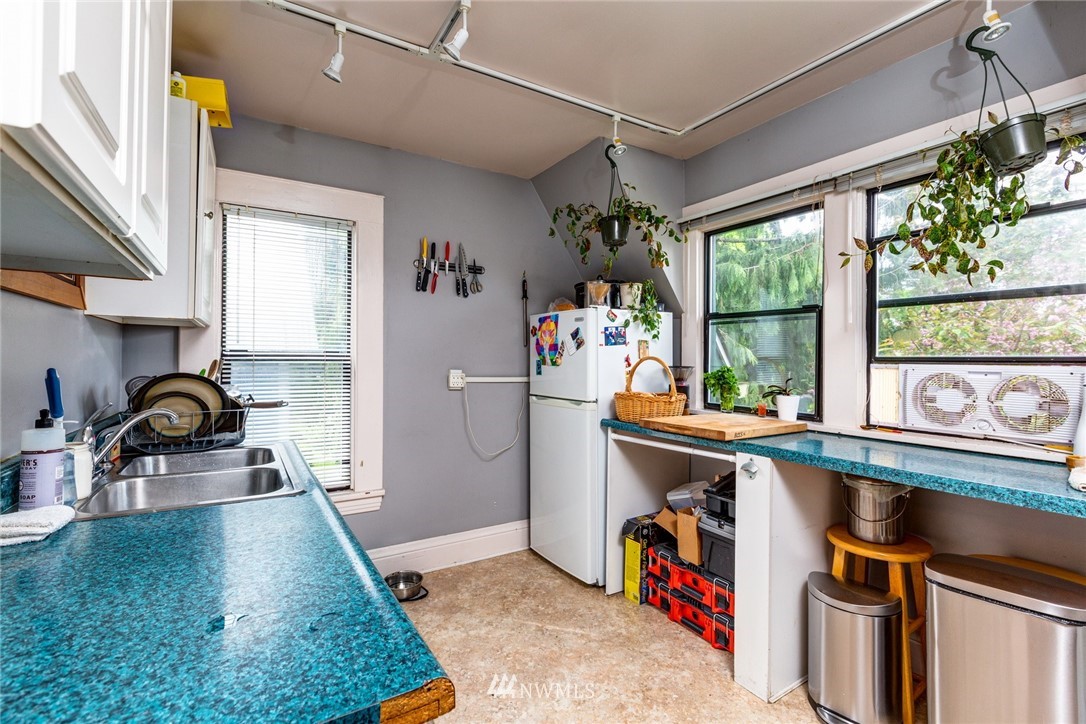 1717 Monroe Street Bellingham, WA 98225 - Photo 28 of 37 a kitchen with a sink a stove and a refrigerator