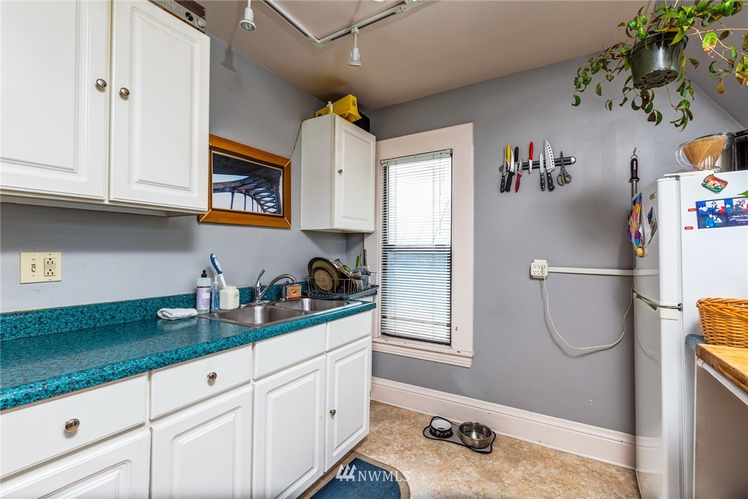 1717 Monroe Street Bellingham, WA 98225 - Photo 29 of 37 a white kitchen with a sink and cabinets