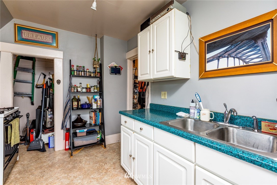 1717 Monroe Street Bellingham, WA 98225 - Photo 30 of 37 a kitchen with stainless steel appliances granite countertop a sink and cabinets