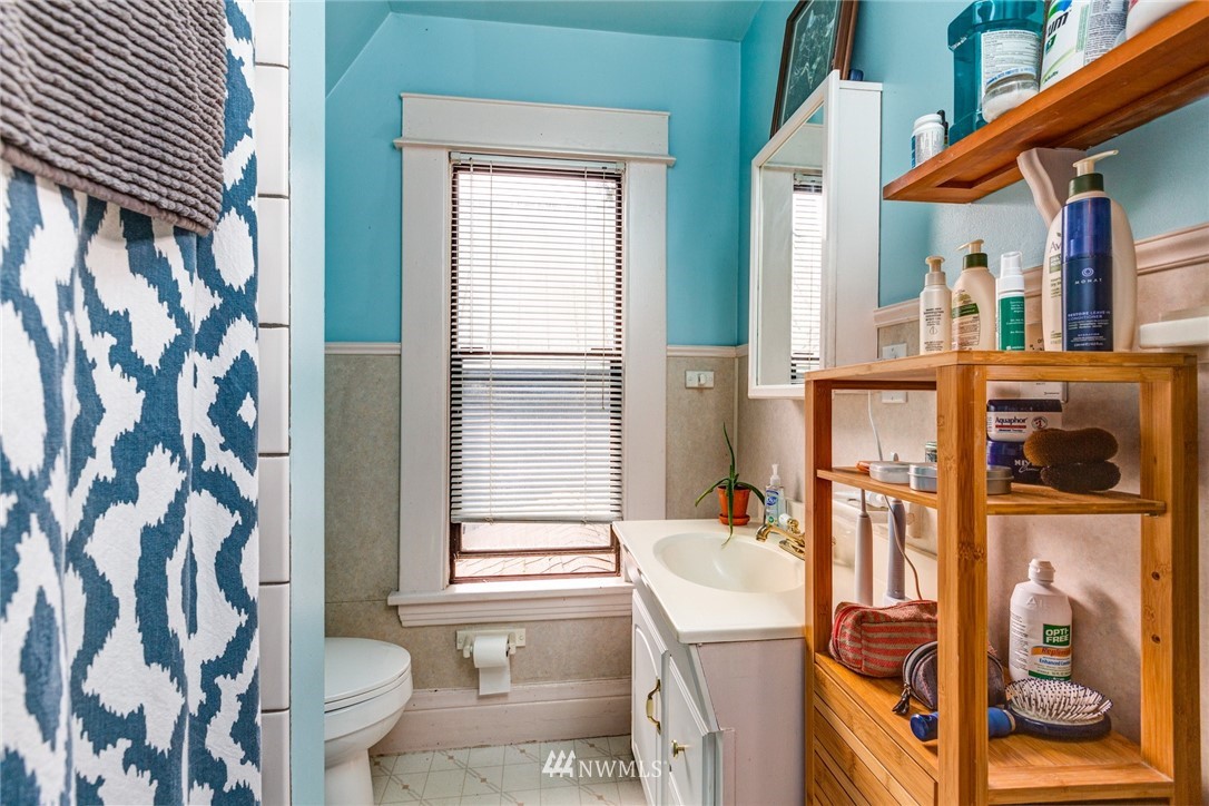 1717 Monroe Street Bellingham, WA 98225 - Photo 31 of 37 a bathroom with a granite countertop sink toilet and shower