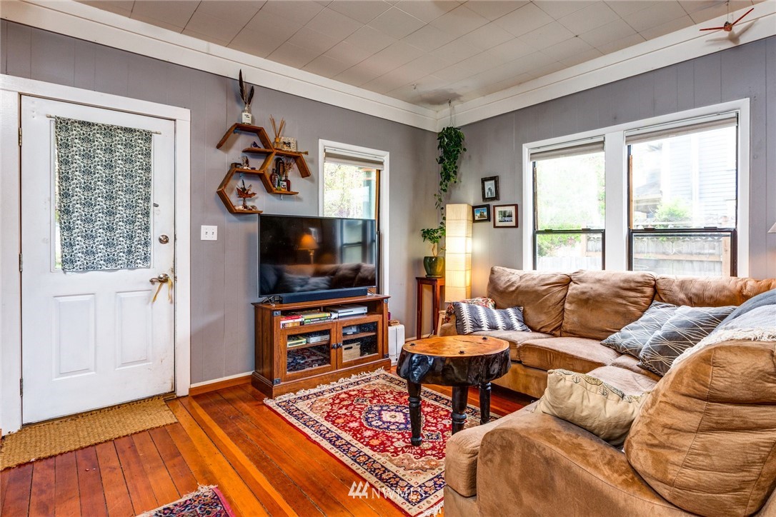 1717 Monroe Street Bellingham, WA 98225 - Photo 5 of 37 a living room with furniture a flat screen tv and a window