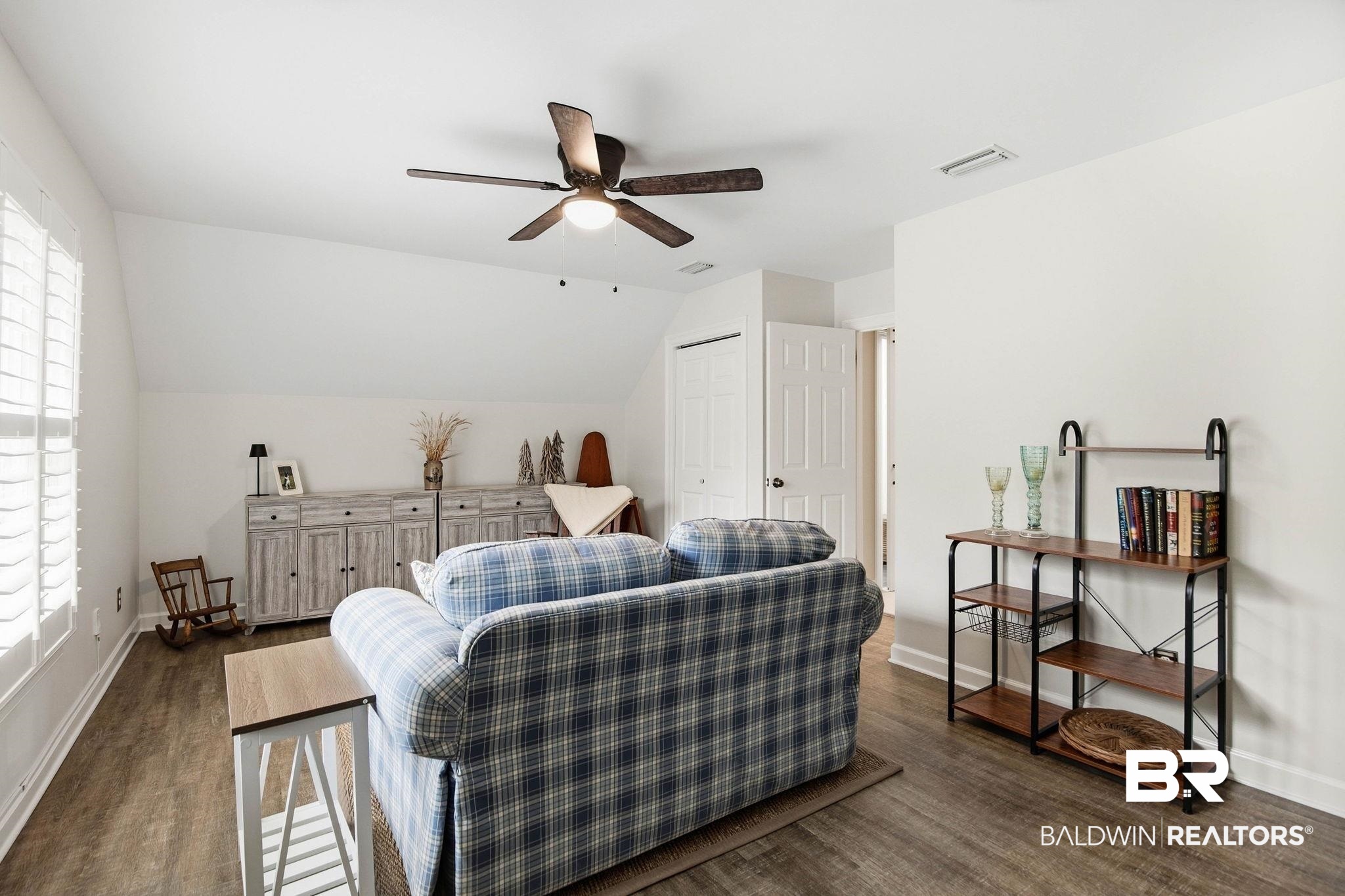 31515 Rhett Drive Spanish Fort, AL 36527 - Photo 59 of 100 Bedroom 5 is being used as a sitting room. The room measures 14' 3" x 19' 4" and has plantation shutters, LVP flooring, a a walk in closet, and an additional closet for storage and has a separate entry to the garage and outside from the second floor.