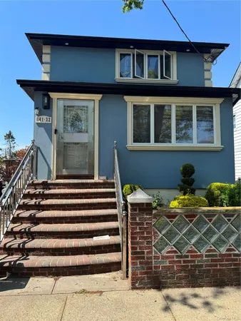 a front view of a house with plants