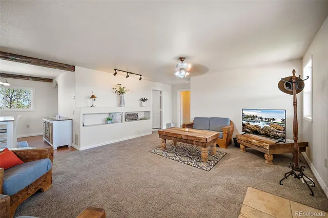a living room with furniture and a chandelier