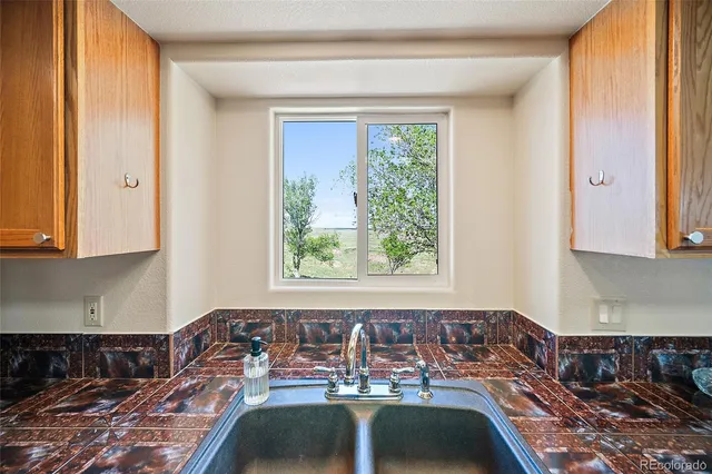 a kitchen with stainless steel appliances granite countertop a sink and a window