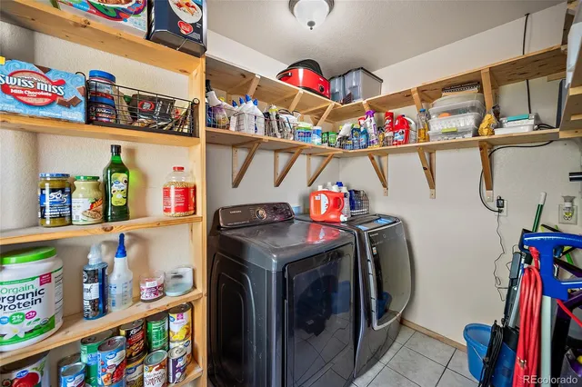 a utility room with dryer washer and other items