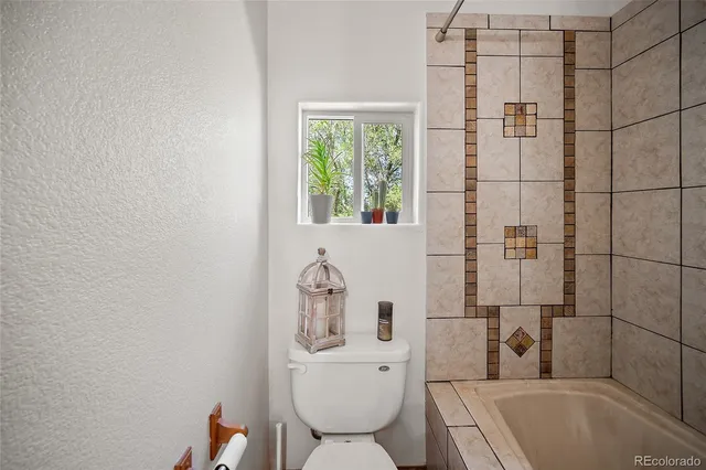 a bathroom with a toilet and shower