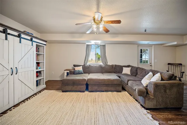 a living room with furniture and a chandelier
