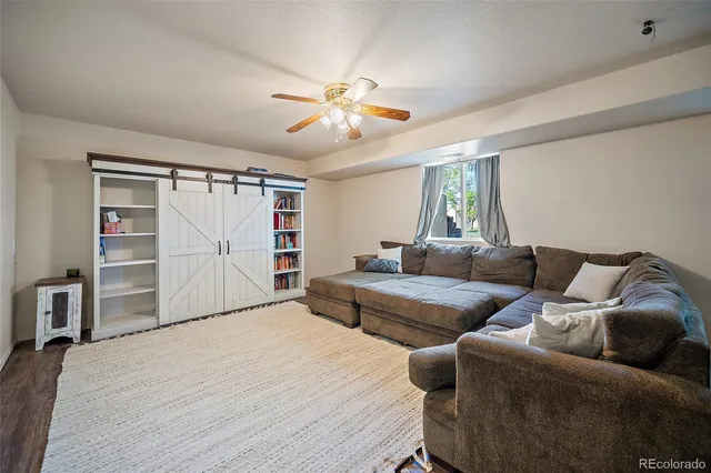 a bedroom with furniture and a ceiling fan