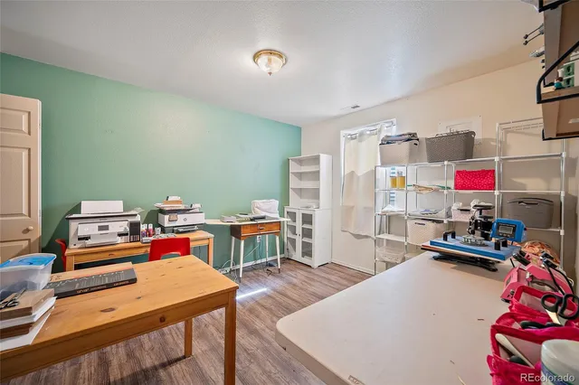 a bedroom with furniture and a wooden floor