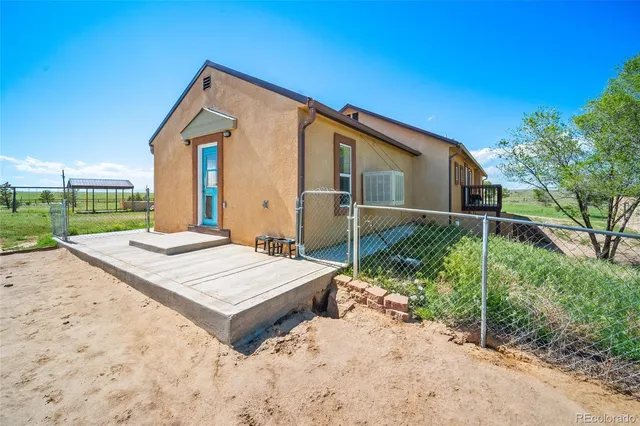 a wooden bench sitting in front of a house