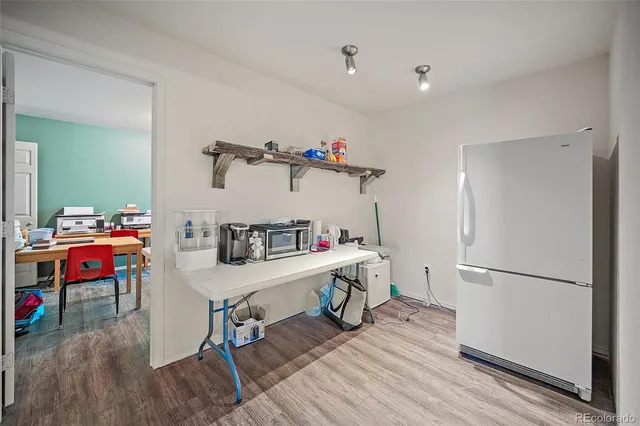 a view of a workspace with furniture and wooden floor