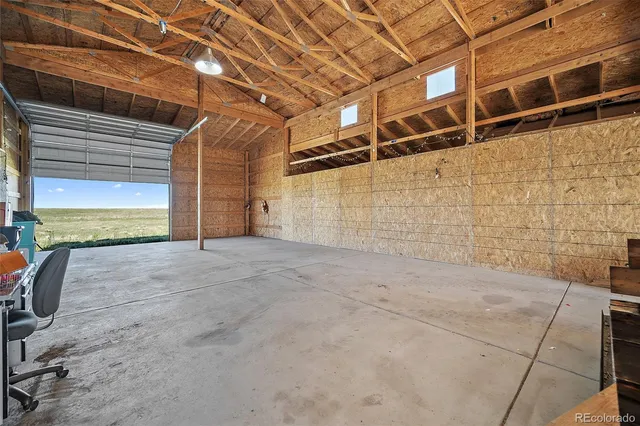 a house with green field in front of it