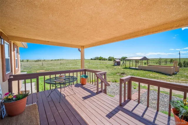 a view of a two chairs on the roof deck