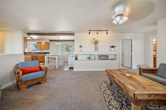 a living room with furniture a dining table and chairs with wooden floor