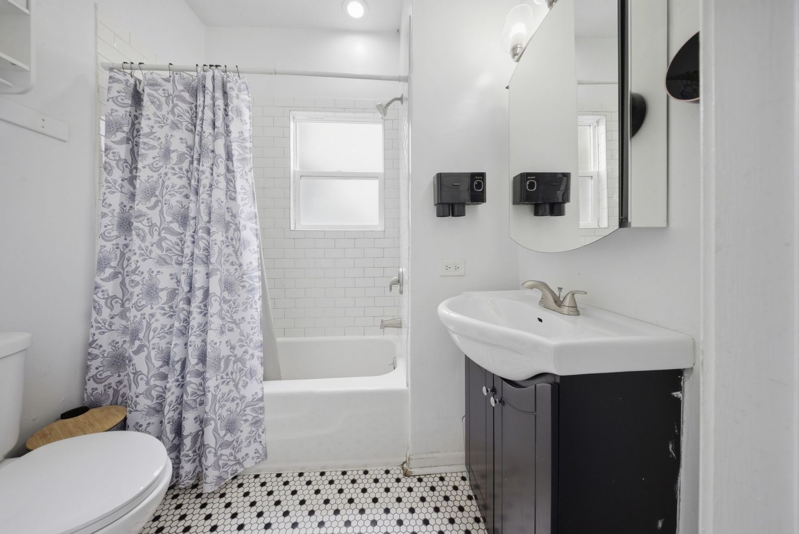 1059 Larkin Avenue Elgin, IL 60123 - Photo 13 of 25 a bathroom with a sink toilet a mirror and shower