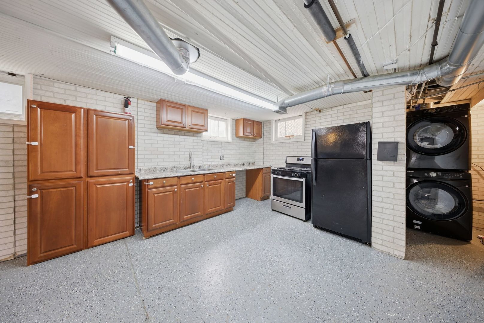 1059 Larkin Avenue Elgin, IL 60123 - Photo 15 of 25 a kitchen with stainless steel appliances granite countertop a refrigerator a stove and a sink