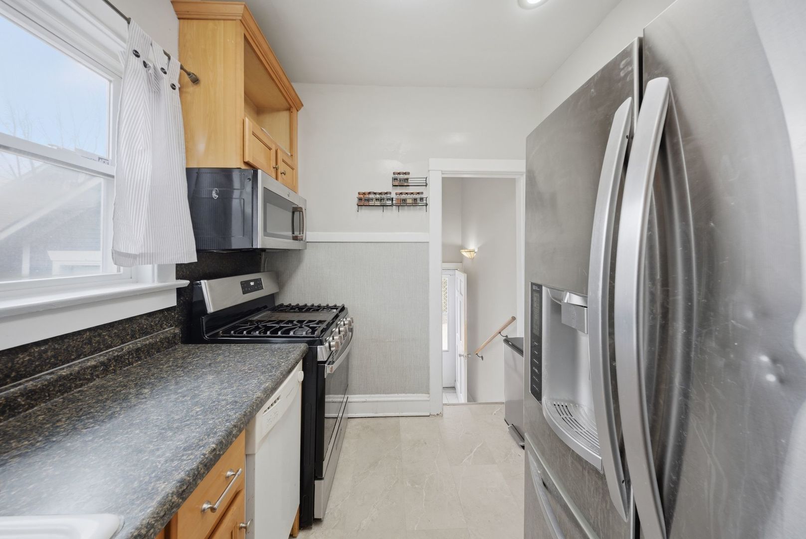 1059 Larkin Avenue Elgin, IL 60123 - Photo 8 of 25 a kitchen with stainless steel appliances granite countertop a refrigerator a sink and white cabinets