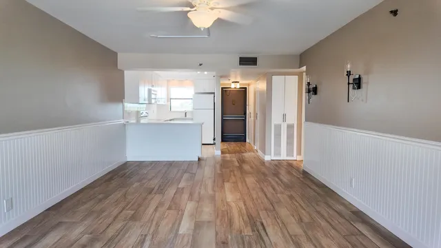 a view of a room with wooden floor and windows