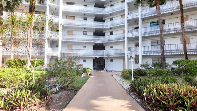 a kitchen with kitchen island a sink appliances a counter space and a window