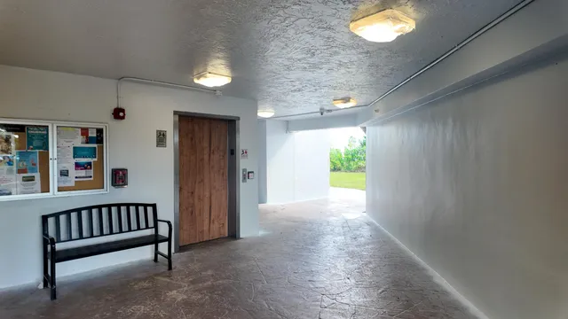 a view of a kitchen with wooden floor and a ceiling fan